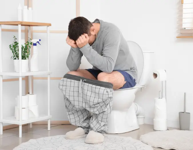 Person suffering from acute digestive upset and diarrhea caused by food sensitivity treated at Dr. L Square Multispecialty Homeopathy Clinic