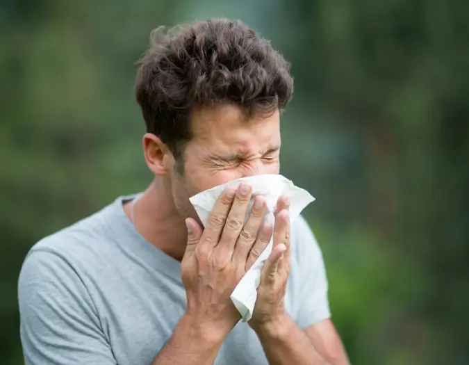 Patient sneezing due to oral allergen contact and food allergy triggers at Dr. L Square Multispecialty Homeopathy Clinic
